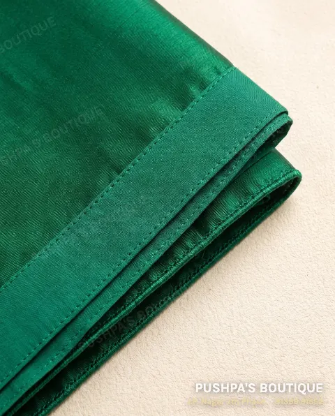 Green silk saree hem folded back to show a matching fall stitched inside and a finished pico edge