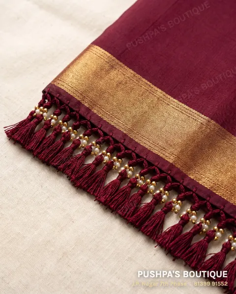 Maroon silk saree pallu finished with beaded kuchu: tassels from the saree's threads with gold beads and pearls
