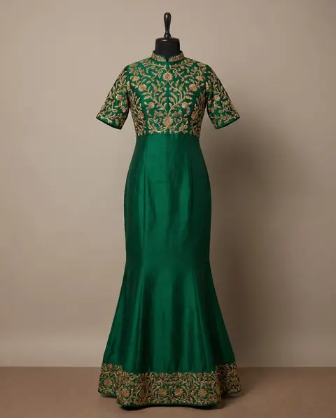 Example of a fish-cut gown: green silk gown fitted to the knee, then flaring into a fish-tail hem with an embroidered border