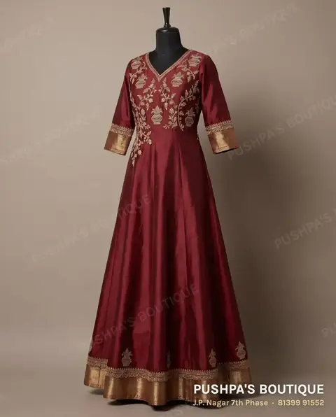 Example of a floor-length flared gown: maroon silk gown with an embroidered yoke and a gold border at the hem