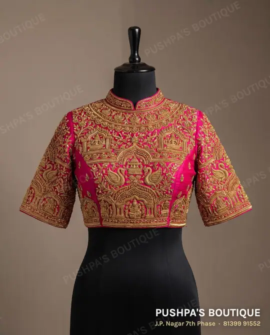 Rani-pink designer bridal blouse with a high neck and dense zardosi and zari work