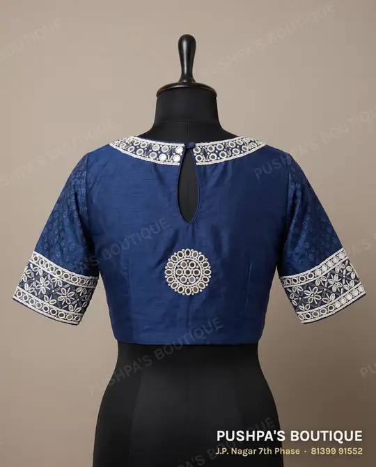 Indigo designer blouse with a mirror and cutdana medallion and mirror bands on the sleeves