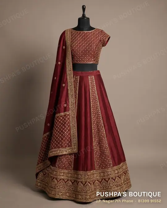 Maroon A-line lehenga with embroidered panels, a wide border and a worked choli