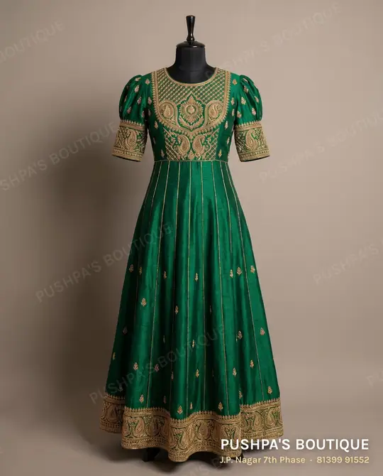 Emerald-green kali gown with an embroidered yoke, kali panels and a zardosi border