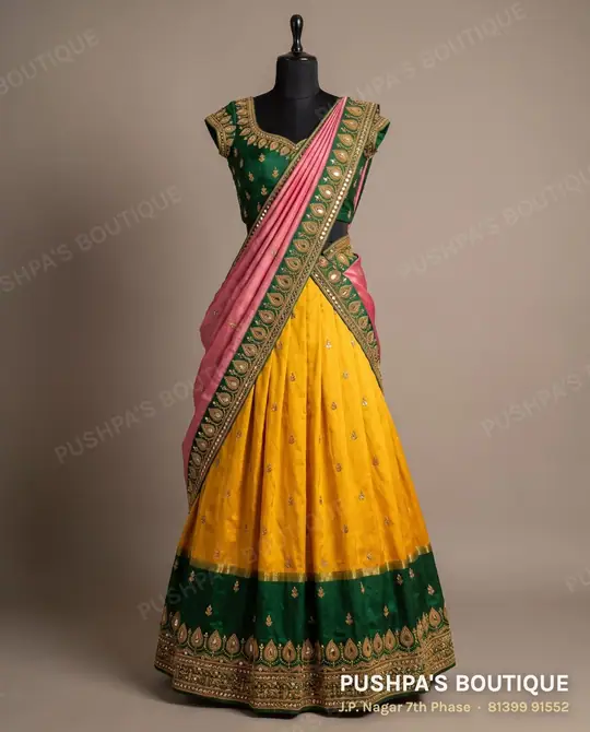 Turmeric-yellow pattu langa with a green and gold border, green blouse and pink davani