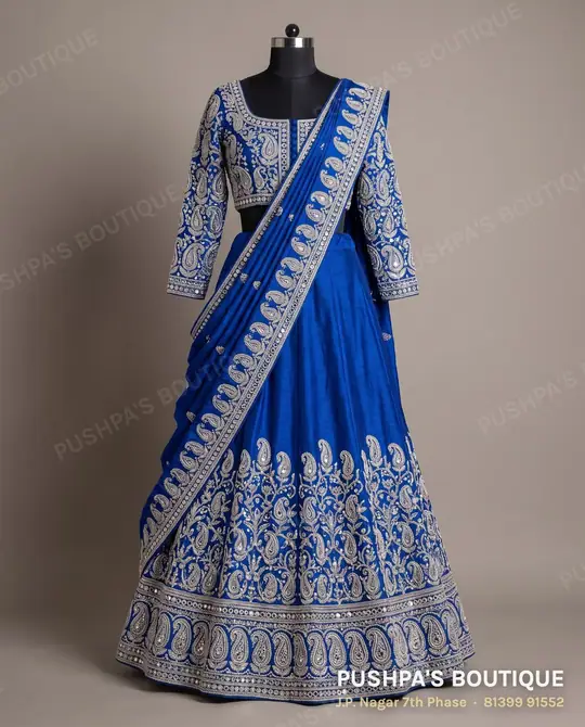Royal-blue half saree with heavy mirror, thread and bead work on the langa border and davani