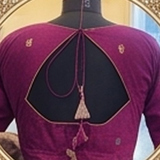 Magenta blouse with an open back, piped edges and tassels